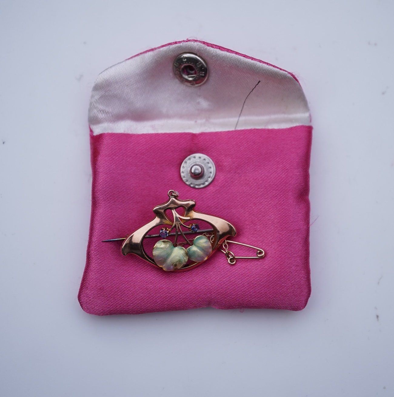 An attractive Art Nouveau enamel, sapphire and seed pearl brooch, early 20th century